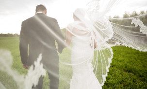 bride-and-groom-walking-with-veil