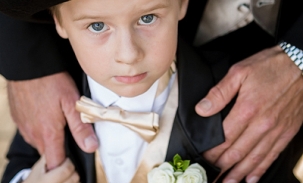 ring-bearer-standing-by-dad