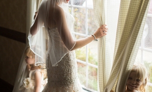 alyssa-in-wedding-dress-with-kids-by-the-window