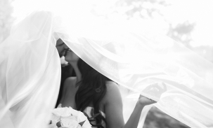 bride-and-groom-kiss-under-veil