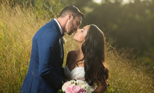 bride-and-groom-kiss-in-tall-grasses